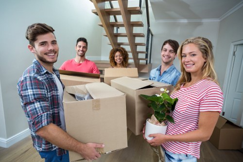 Movers working near a modern Bankside riverside apartment building